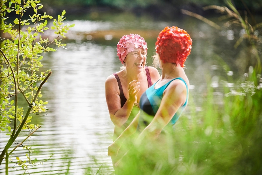 Two ladies laughing in rural river