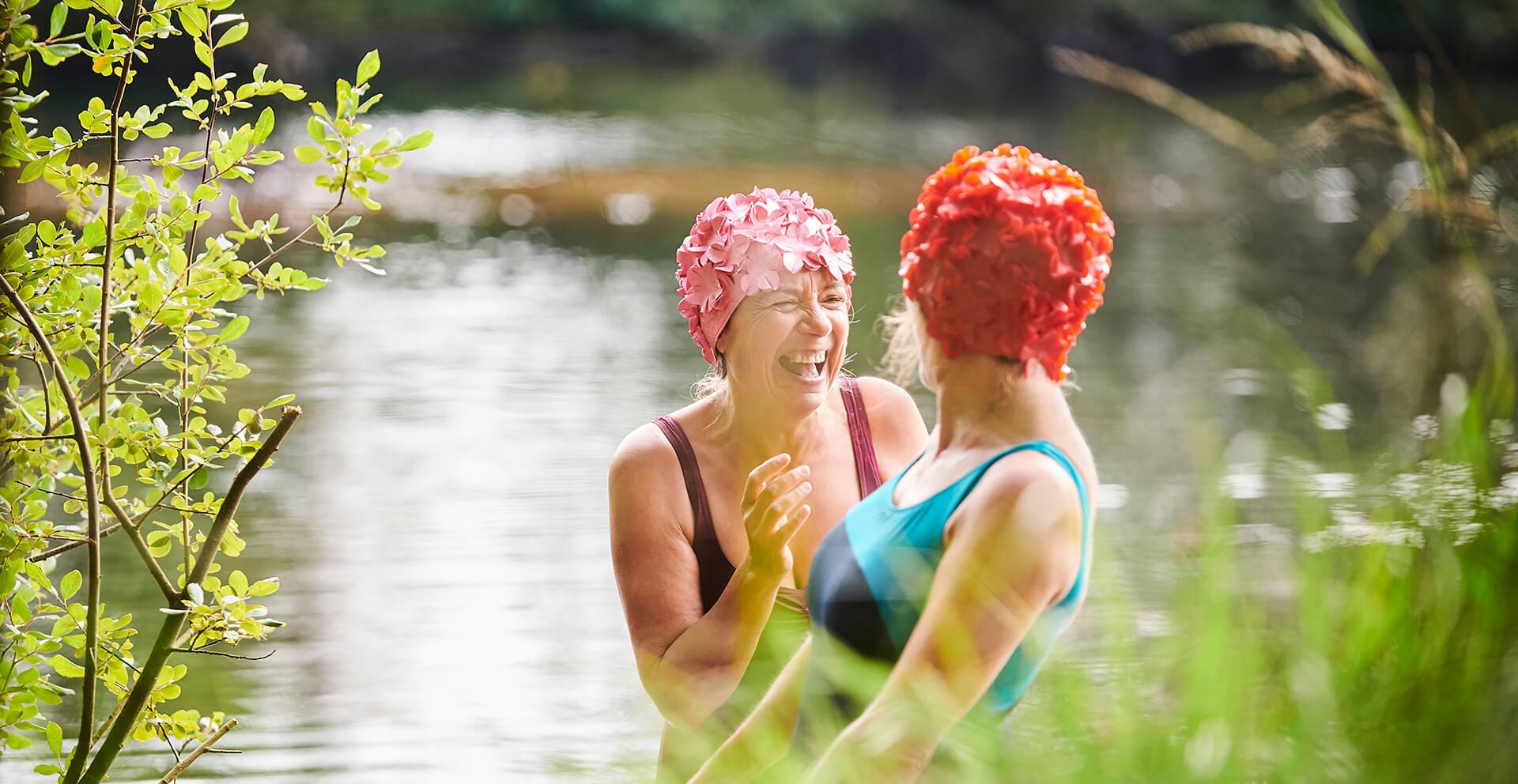 Two ladies laughing in a rural river