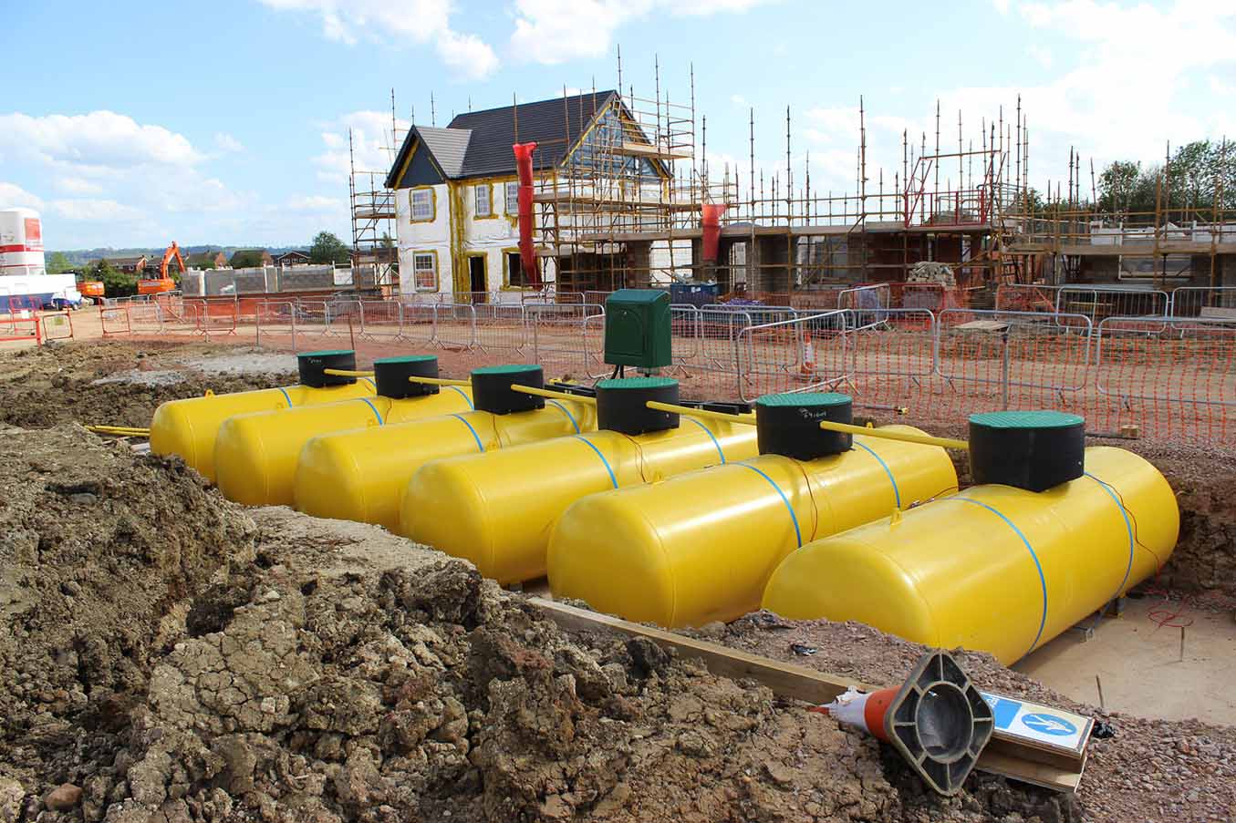 Several yellow LPG underground tanks in a row