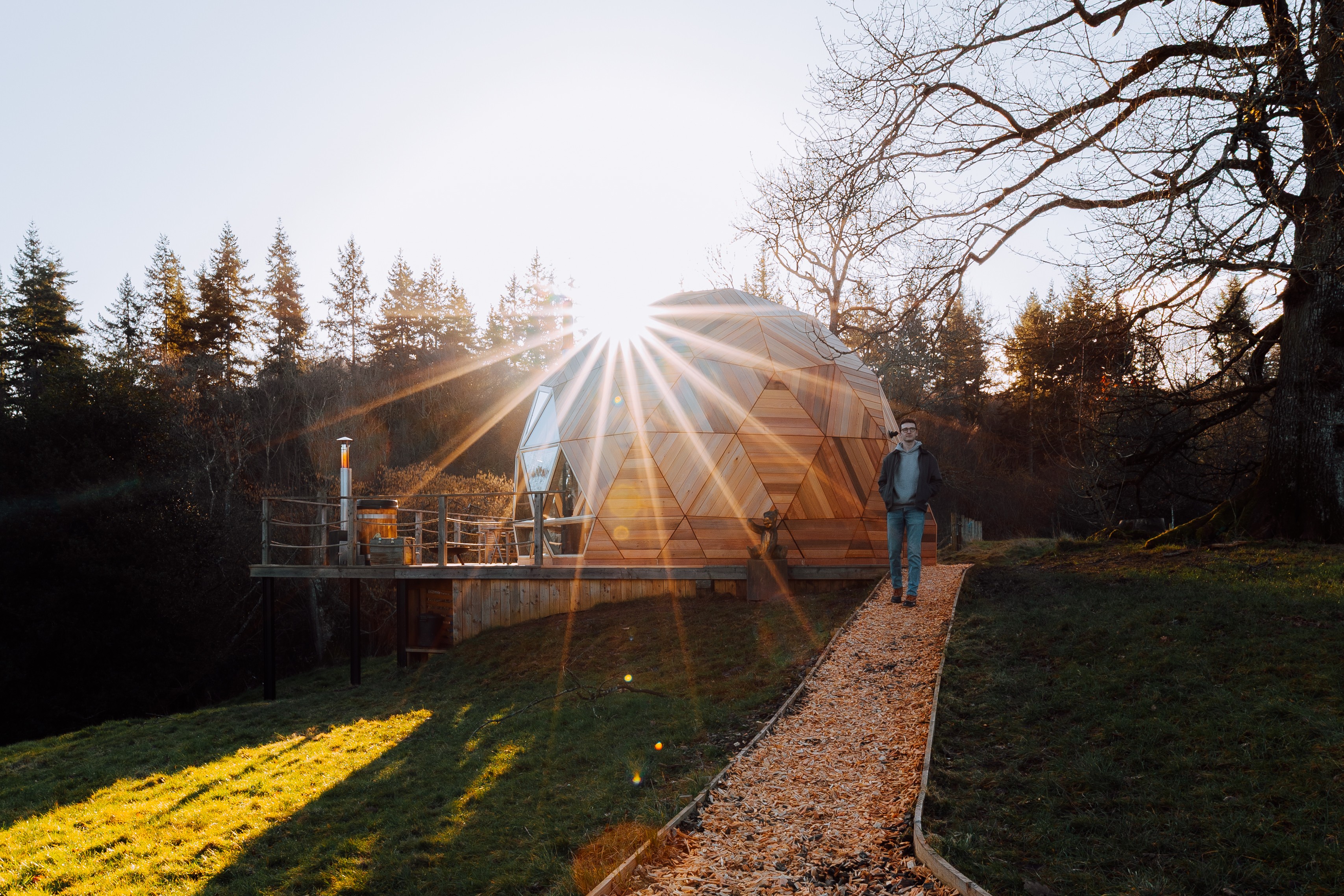 The fold and a cabin with the sun shining with owner in the image. 