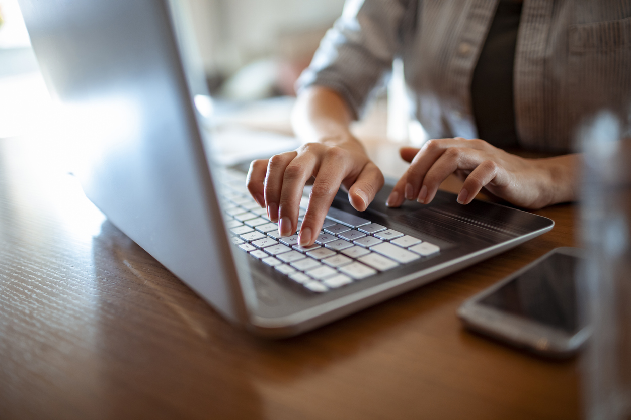 woman typing on a laptop