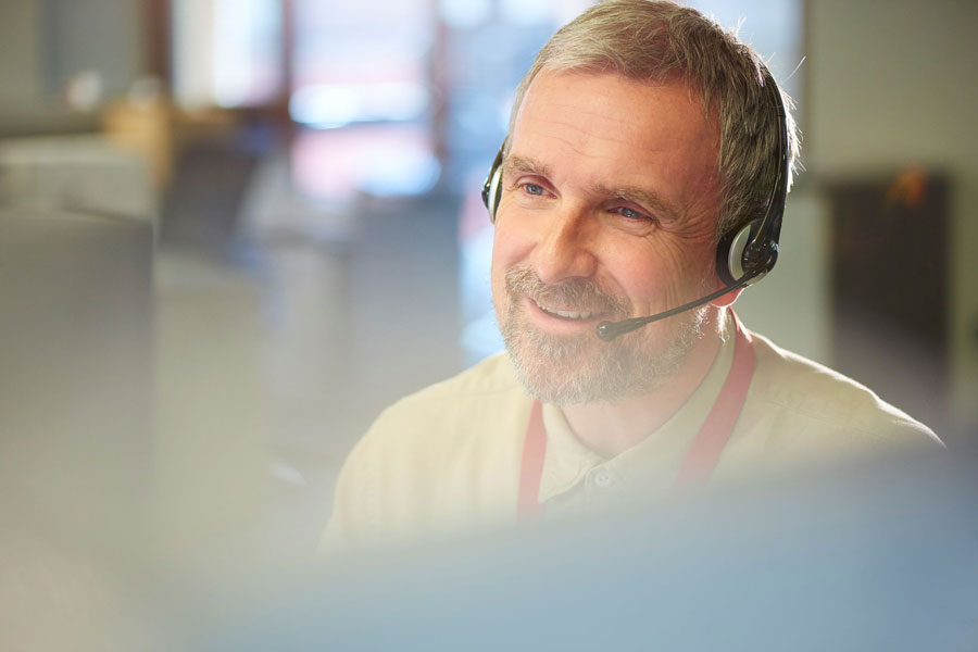 Man in an office with a headset