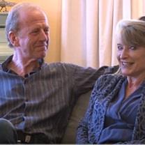 Two Calor customers sitting comfortably on their sofa in their home