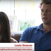 Two of Calor’s customers are sitting down on a sofa in their home. One of the customers is Louis Deacon, a former English professional Rugby Union player